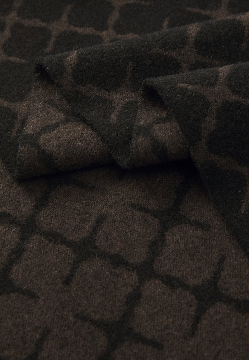 Textured fabric featuring a geometric pattern in dark brown and black. Soft wool blend with a fuzzy surface, folded to show detail.