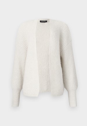 Vit stickad cardigan med en avslappnad passform, öppen front och långa, något puffiga ärmar. Har en strukturerad tygkvalitet och ribbade manschetter.
