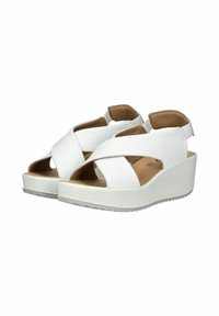 Sandali wedge bianchi presentano cinghie incrociate, una punta aperta e una soletta imbottita beige. La suola è texturizzata per offrire aderenza.