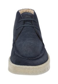 Marine blauwe suède schoen met een ronde neus, voorzien van twee vetersleuven, een getextureerde zool en een beige crepe rubbere loopzool. Schoon, minimalistisch ontwerp.