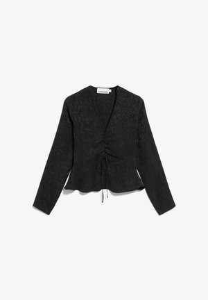 Blouse noire à manches longues avec un motif texturé, devant cintré et détail à cordon. Ourlet évasé et décolleté en V profond.