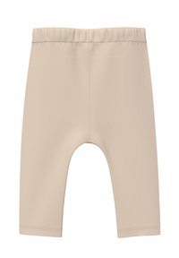 Beige cropped shorts gemaakt van zachte, gestructureerde stof. Heeft een elastische tailleband en een ronde uitsnijding aan de onderzoom voor bewegingsvrijheid.