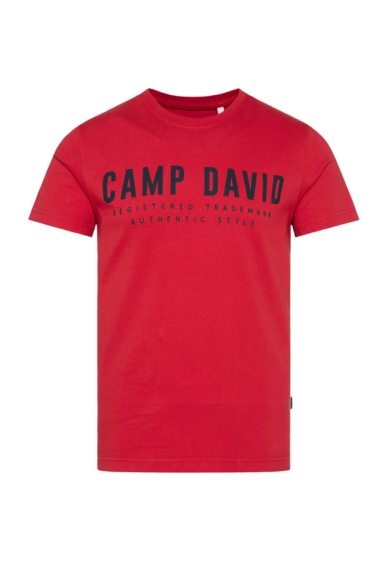 Red cotton t-shirt featuring black printed text "CAMP DAVID REGISTERED TRADEMARK AUTHENTIC STYLE" on the front. Short sleeves, crew neck design.