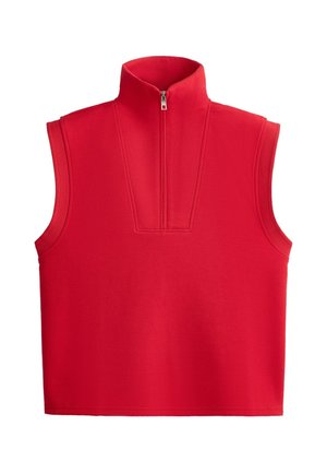 Gilet rouge sans manches avec col montant et fermeture demi-zip sur le devant, en tissu lisse, présenté sur fond blanc uni.