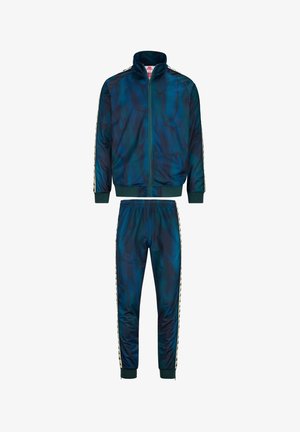 Tuta in blu scuro e motivo marmorizzato verde, realizzata in materiale sintetico. Presenta una giacca con zip e pantaloni con vita elasticizzata e strisce laterali.