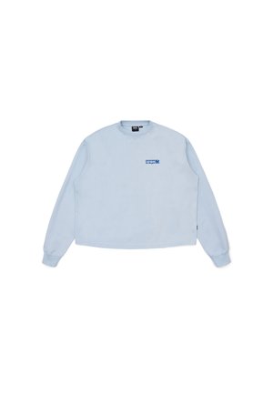 Light blue long-sleeve sweatshirt with crew neck, featuring a small blue graphic logo on the chest and ribbed cuffs. Soft fabric texture.