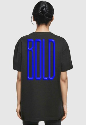 Black oversized t-shirt with short sleeves, featuring a large blue "BOLD" graphic on the back. Cotton material with a smooth texture.