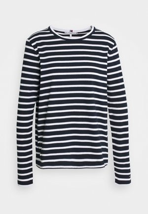 Camisa de manga larga con rayas horizontales en azul marino y blanco. Fabricada con tejido suave, tiene un cuello redondo y un dobladillo cosido.