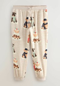 Heledadbeige pajama püksid, millel on kogu pinna ulatuses talvise riietusega koomiksiloomade muster. Pehme kangas, elastne vöökoht ja mansetid.