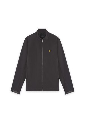 Μαύρο μπουφάν με φερμουάρ, ψηλό γιακά, μακρυά μανίκια και μικρό κίτρινο κεντητό λογότυπο πουλιού στο αριστερό στήθος.