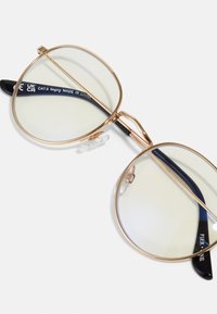 Gold metal-framed eyewear with round, light tinted lenses. Thin temples with black accents. Adjustable nose pads for comfort.