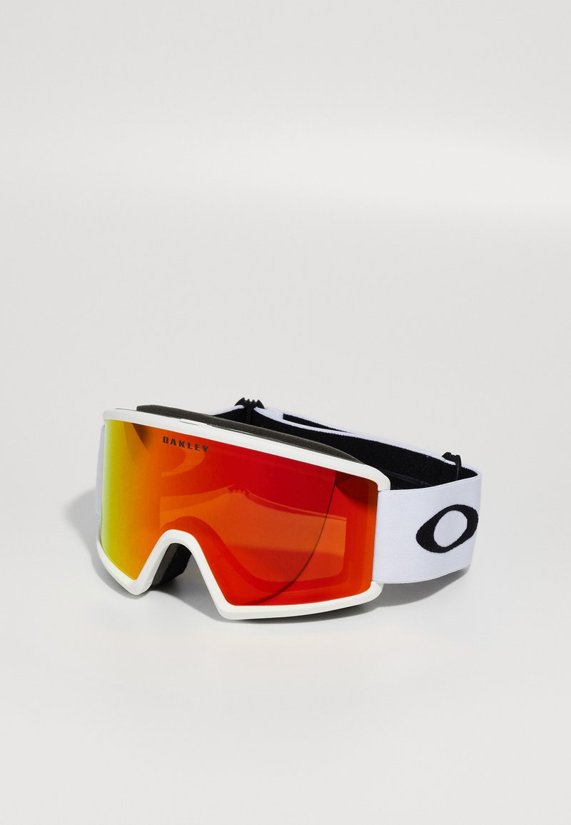 Lunettes de ski avec une monture blanche, des verres dégradés rouges et une sangle ajustable noire et blanche. Présentent un design large et enveloppant pour une meilleure visibilité.