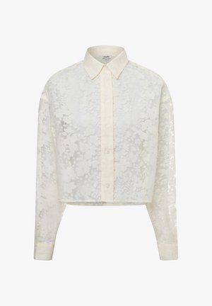 Cropped blouse in white sheer fabric with floral pattern. Features long sleeves, a classic collar, and button front closure.