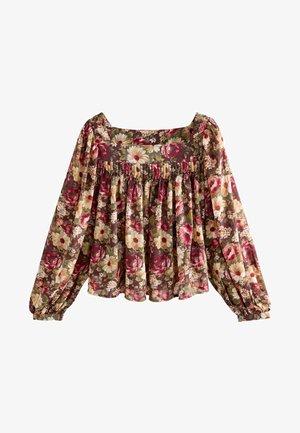 Lille kangast lillemusterne pluus, millel on ruudukujuline kaelus, pikad varrukad elastsete mansettidega ja kogu detail vöökohtadel.