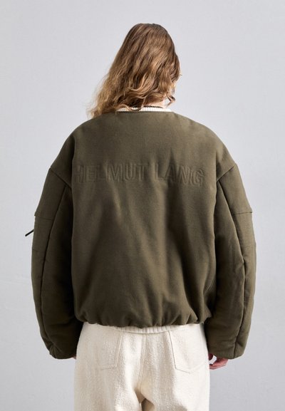 Olive green oversized sweatshirt with embroidered "HELMUT LANG" logo on the back. Soft fabric, ribbed cuffs, and hem. Casual design.