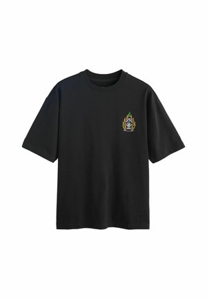 Black short-sleeve T-shirt with small graphic of a flaming hot sauce bottle on the left chest area.