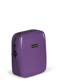 Paarse reistas met een glanzende afwerking, verticale ribbelpatroon en een zwarte rits. Bevat een zwart logo-label aan de voorkant. Compact ontwerp.