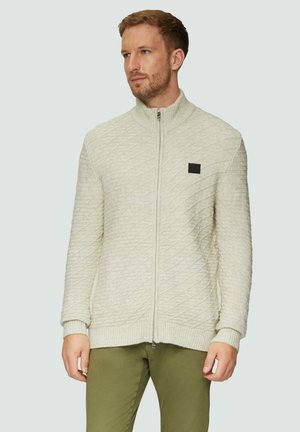 Lichtbeige zip-up vest met een ruitpatroon, geribbelde manchetten en hoge kraag. Bevat een klein zwart logo op de borst.