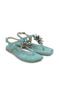 Turquoise suede sandals with a thong design, featuring floral rhinestone accents, flat sole, and ankle strap with metal buckle.