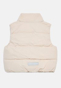 Beige vadderad väst med hög krage och horisontellt kviltad design samt en rektangulär etikett på baksidan. Slät textur, ärmlös stil.