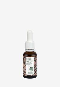 Brun glassflaske med en hvit dråpetopp, merket "ansiktsserum" med bladmønstre i dempet rosa og grønn. Inneholder tea tree olje.