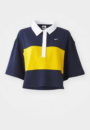 Short-sleeve polo shirt with a navy body, yellow horizontal stripe, and white collar. Features Nike logo in white on the chest. Cotton blend fabric.