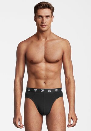 Schwarze Herrenunterhosen mit einem weißen "CR7"-Logo am Bund, aus einem glatten, dehnbaren Material gefertigt, mit einem konturierten Vorderdesign.