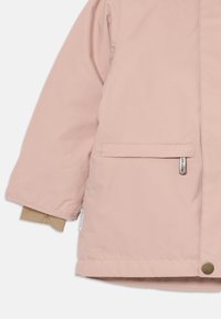 Giacca invernale rosa per bambini con maniche e tasche con polsini interni beige e piccole etichette del marchio visibili.