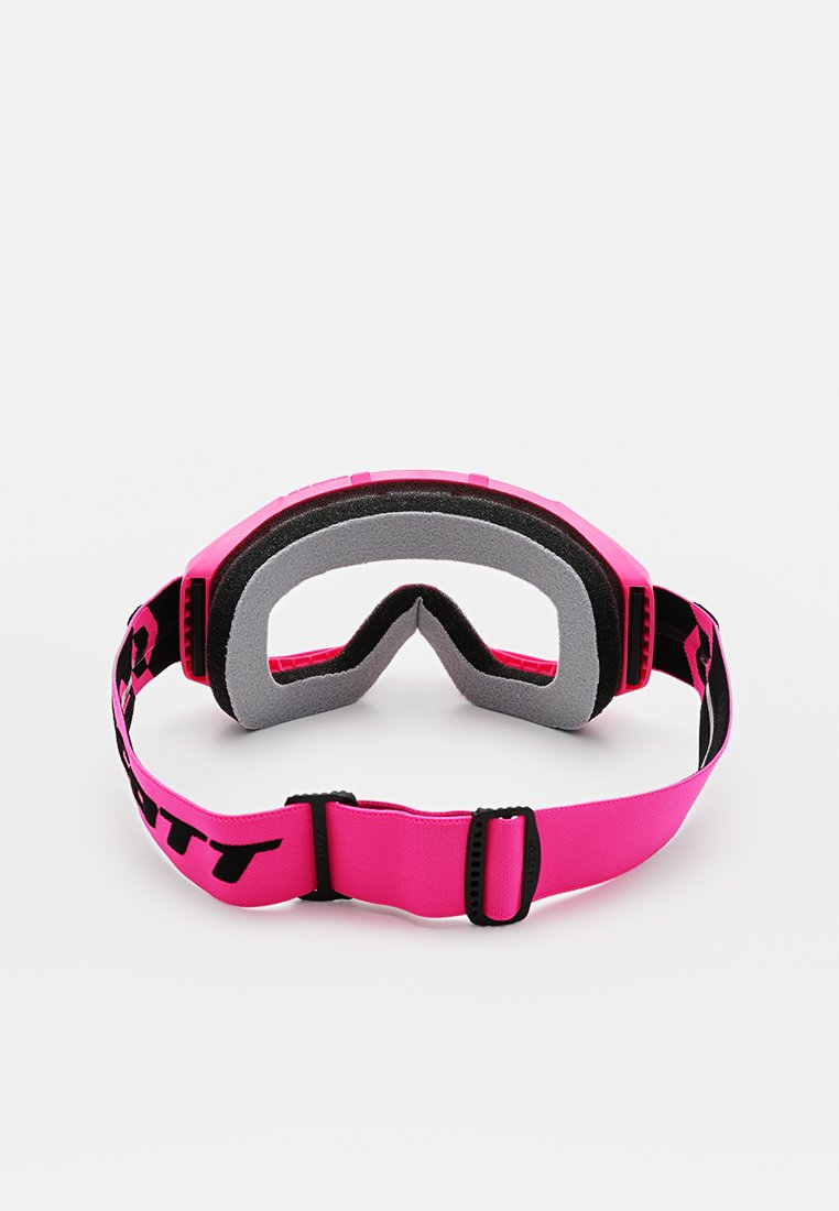 Różowe gogle narciarskie z miękkim wnętrzem z pianki, regulowanym paskiem i opływowym kształtem. Posiadają kontrastowe, ciemne logo na pasku.