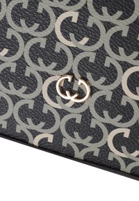 Sort læderaccessory med en struktureret overflade, der har sammenflettede C-mønstre i lysegrå og en guld logo detalje.