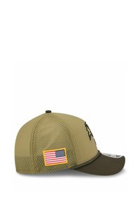 Olivgrüne Kappe mit Mesh-Rücken, versehen mit einem erhabenen schwarzen Emblem und einem rechteckigen US-Flaggen-Patch. Geformter Schirm und strukturierter Stoff.