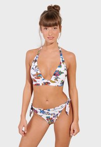 Bikini set with a halter neck top and tie-side bottoms. White fabric featuring colorful abstract patterns. Smooth texture and fitted design.