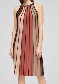Robe sans manches en tricot avec des rayures verticales dans des tons rouille, rose et marron avec des accents noirs. Texture lisse, corsage ajusté et ourlet évasé.