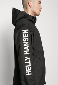Helly Hansen ERVIK - Regenjas - black