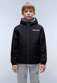 Black hooded jacket with a zip front, elastic cuffs, logo on the chest, and gray lining. Worn over light gray sweatpants.