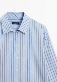 Light blue button-up shirt with vertical stripes in darker tones, featuring a classic collar and smooth fabric texture.