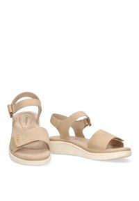 Sandali beige con due fibbie larghe, retro regolabile e suola sagomata. Materiale morbido simile alla pelle scamosciata con una finitura testurizzata.