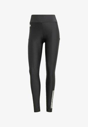 Black leggings made of stretchy fabric. High-rise waist, slim fit, featuring three white stripes along the side. Smooth texture, no visible hardware.