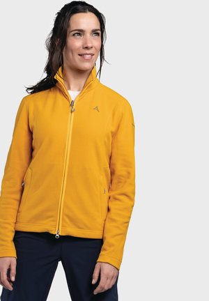 Yellow fleece jacket with a high collar, front zip, and side pockets. Features a logo on the chest and a textured fabric surface.