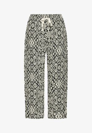 Black and white patterned pants with an elastic waist, drawstring closure, and a geometric design featuring diamonds and floral motifs.