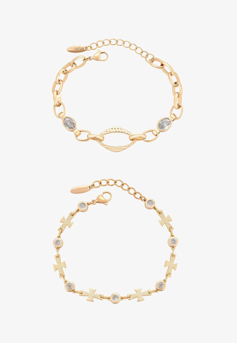 Dwie bransoletki w złotym odcieniu: jedna z owalnymi kryształami i teksturowanymi ogniwami, druga z naprzemiennymi krzyżami i okrągłymi kryształami.