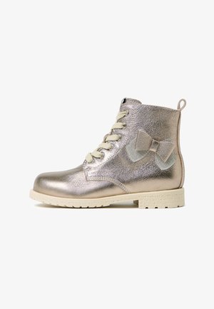 Metallic gold ankle boots with a textured finish, beige laces, and a decorative bow accent on the side. Rubber sole for traction.