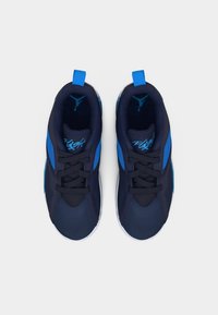 Ζευγάρι αθλητικών παπουτσιών σε ναυτικό μπλε και φωτεινό μπλε με μαύρα κορδόνια, λευκές σόλες και τη λέξη «Flight» στην περιοχή της φτέρνας.