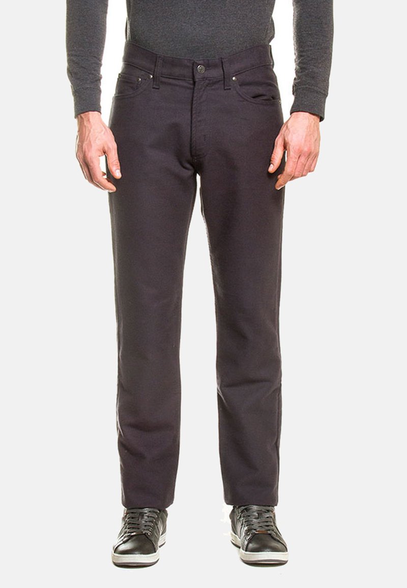 Jeans grigio scuro in cotone, con taglio dritto, cinque tasche, chiusura con bottone e dettagli in metallo. Indossati con sneakers nere.
