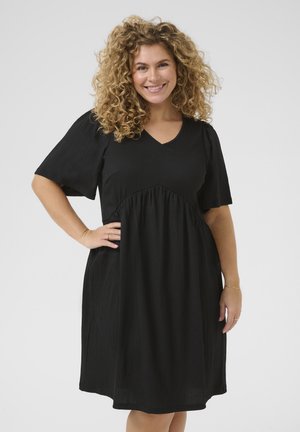 Zwarte jurk met korte mouwen, V-hals en een geraffineerde taille. Gemaakt van textiel met structuur, heeft een relaxte pasvorm en een subtiele val.