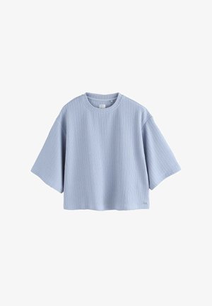 Lichtblauw cropped t-shirt gemaakt van geribbelde stof. Heeft een ronde halslijn en brede korte mouwen. Eenvoudig en functioneel ontwerp.