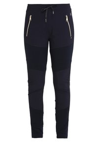 Pantalones deportivos negros con bolsillos con cremallera, paneles en contraste y cintura con cordón. Fabricados con un material elástico y duradero.