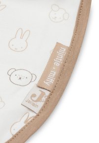 Witte stof met beige rand featuring eenvoudige afdrukken van beren- en konijnen gezichten en twee stoffen labels, eentje met de tekst "milktee . milky" en de andere "Jollein."