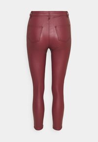 Burgundy fusk läderleggings med en smidig, glänsande yta. Har två bakfickor och en åtsittande design som blir smalare vid anklarna.