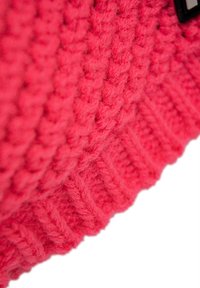 Chunky knitted sweater in bright pink. Features a textured pattern with ribbed hem. Soft fabric with a comfortable, cozy look.